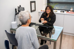 talking to patient about dental implants in dental office